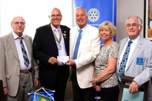 Philip White, chairman of the Clive Olney fund trustees, hands over the cheque for ï¿½15,242 to Torquay Rotary Club president Roger Avenall, accompanied by, from left, Brian Chudley, Cliveï¿½s widow Jackie, and John Flude. 